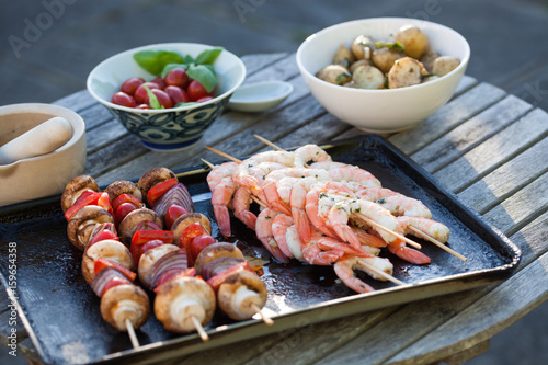 barbecue in the garden - summer- prawns and vegetables on skewers