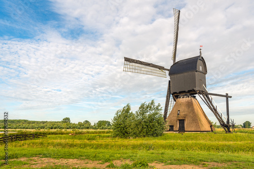 Dutch thatched stone hollow post mill with wooden upper house originally built in 1795 photo