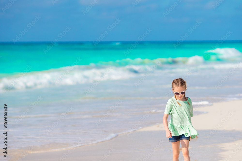 Happy little girl walking on the white beach Happy little girl walking on the white beach