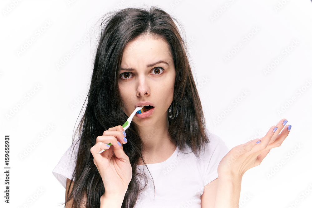 Woman brushes teeth on isolated background portrait Woman brushes teeth on isolated background portrait