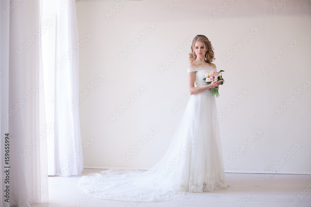 bride in wedding dress holding a bouquet of flowers bride in wedding dress holding a bouquet of flowers