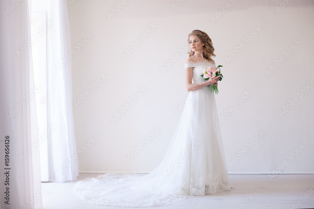 bride in wedding dress holding a bouquet of flowers bride in wedding dress holding a bouquet of flowers