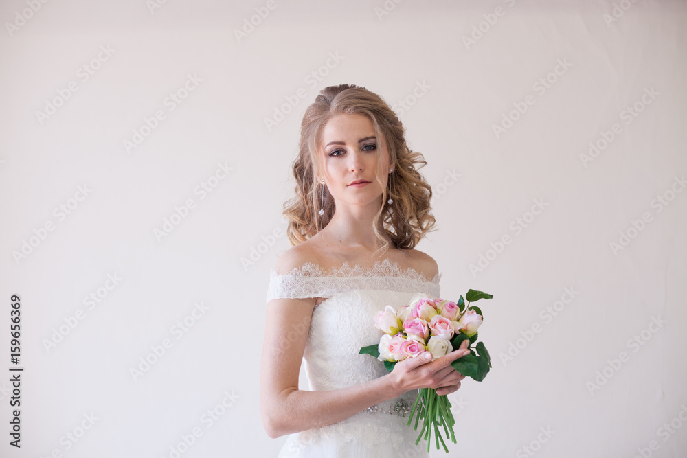 bride in wedding dress holding a bouquet of flowers
