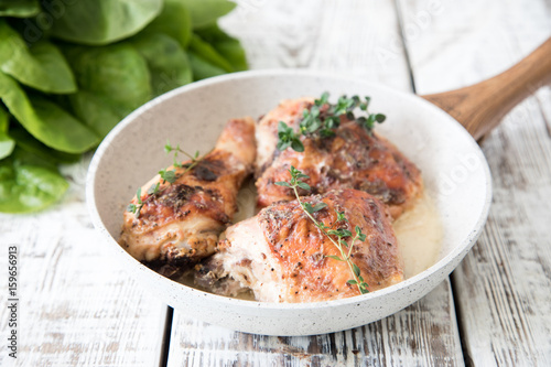 Fried golden chicken thighs with spices and herbs. Baked chicken legs