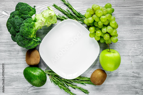 organic food for homemade salad with green vegetables and plate gray desk background top view mock-up