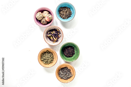 Tea-party with different herbal tea on white desk background flat lay mock up