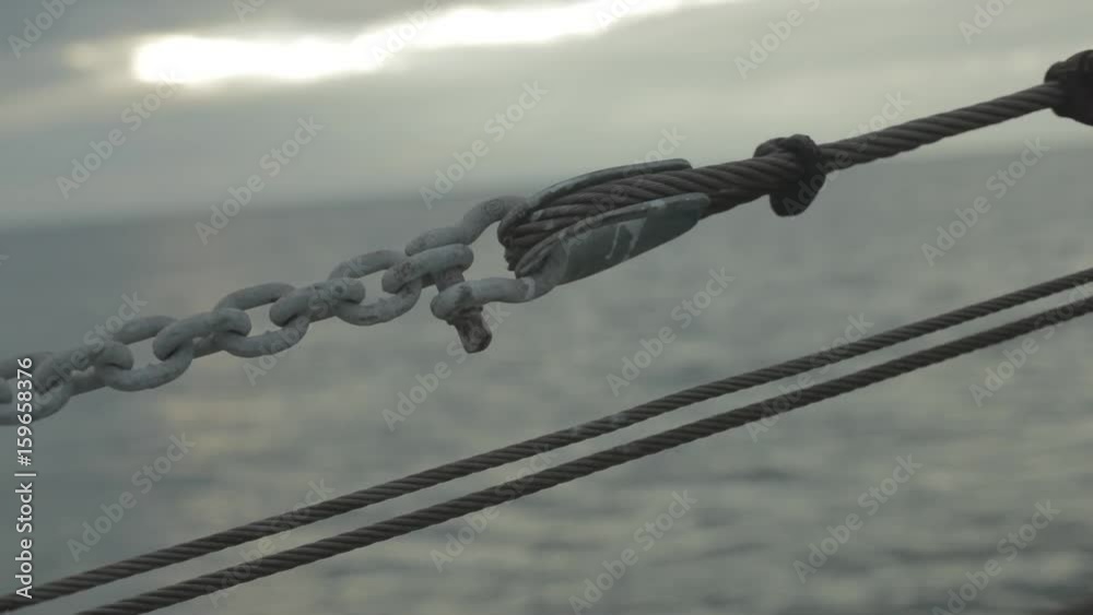 Chain and steel cable on boat with ocean Chain and steel cable on boat with ocean