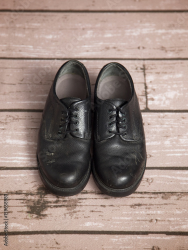 Old Black Dress Shoes on a Wooden Floor