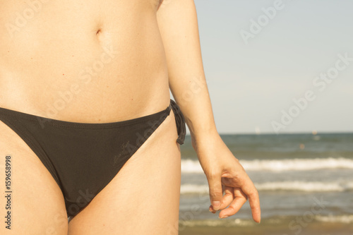 Young lady in bikini on beach