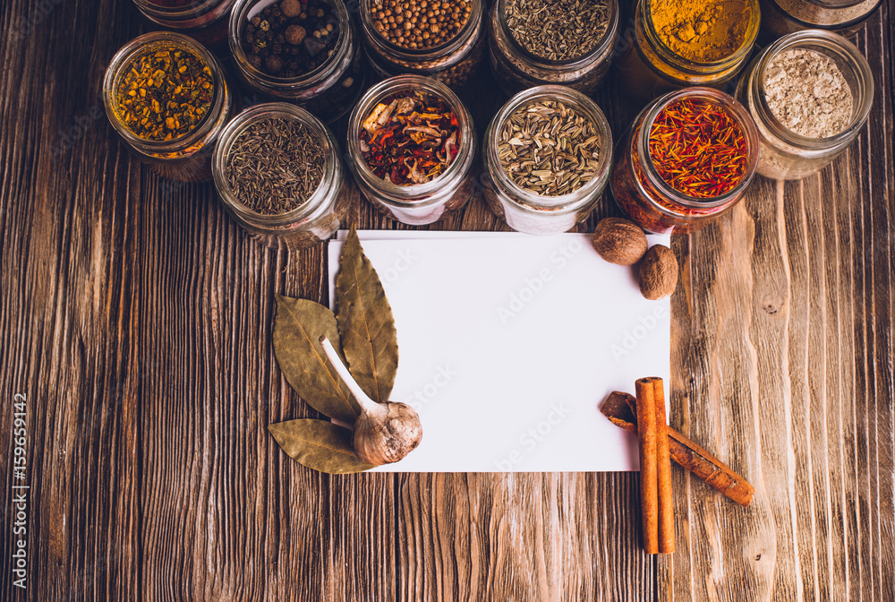 Various colorful kinds of spices on rustic wooden table, top view with copy space Various colorful kinds of spices on rustic wooden table, top view with copy space