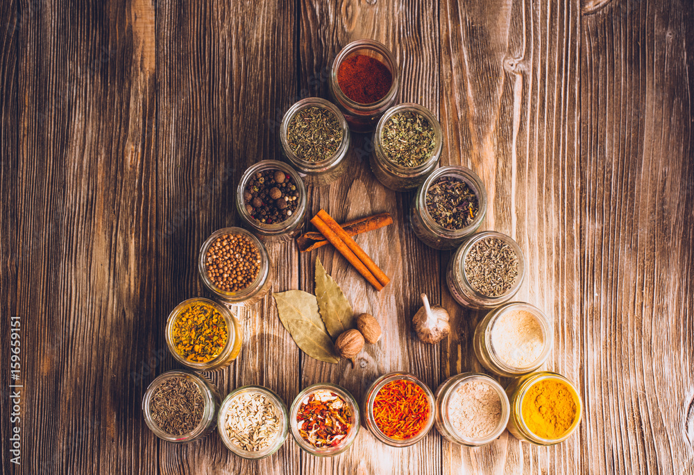 Various colorful kinds of spices on rustic wooden table, top view Various colorful kinds of spices on rustic wooden table, top view