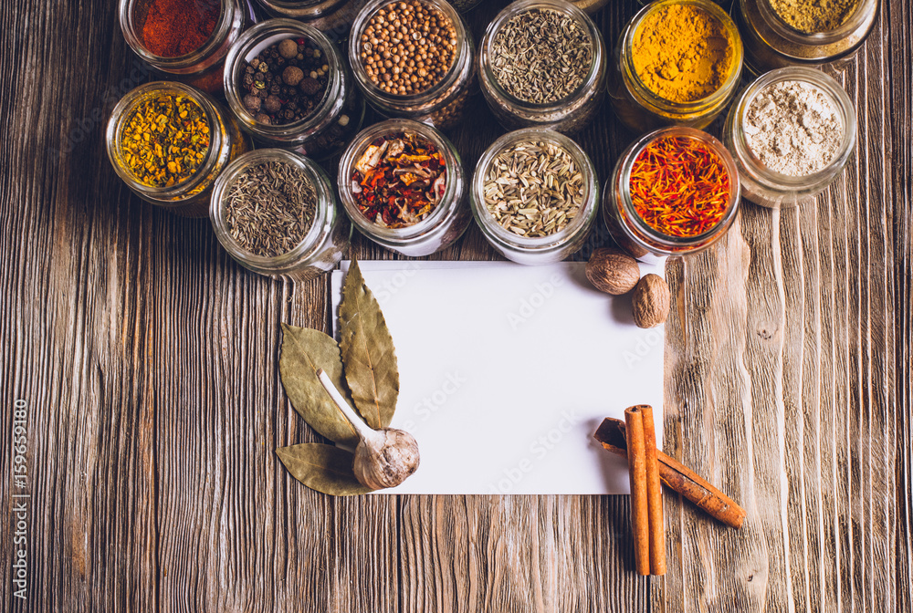 Various colorful kinds of spices on rustic wooden table, top view with copy space Various colorful kinds of spices on rustic wooden table, top view with copy space