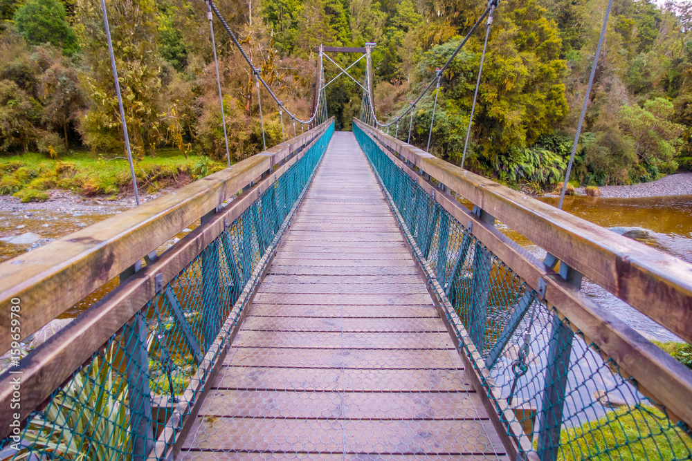 Suspension bridge in southwest in National Park, located in New Zealand Suspension bridge in southwest in National Park, located in New Zealand