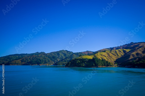 Beautiful landscape of mountain with gorgeous blue sky in a sunny day seen from ferry from north island to south island  in New Zealand