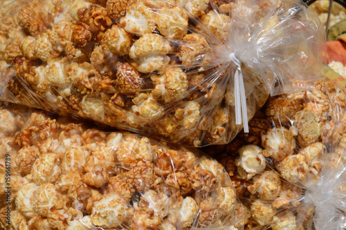 Spicy caramel covered kettle corn popcorn in large bags at farmer's market photo