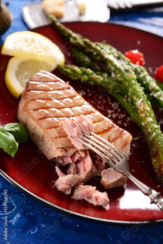 Grilled Tuna steak with roasted asparagus and parmesan photo