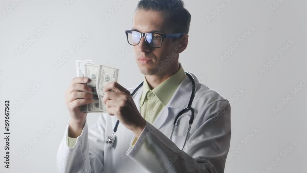 Doctor counts the money. A bribe to a medical worker. Expensive medicine.