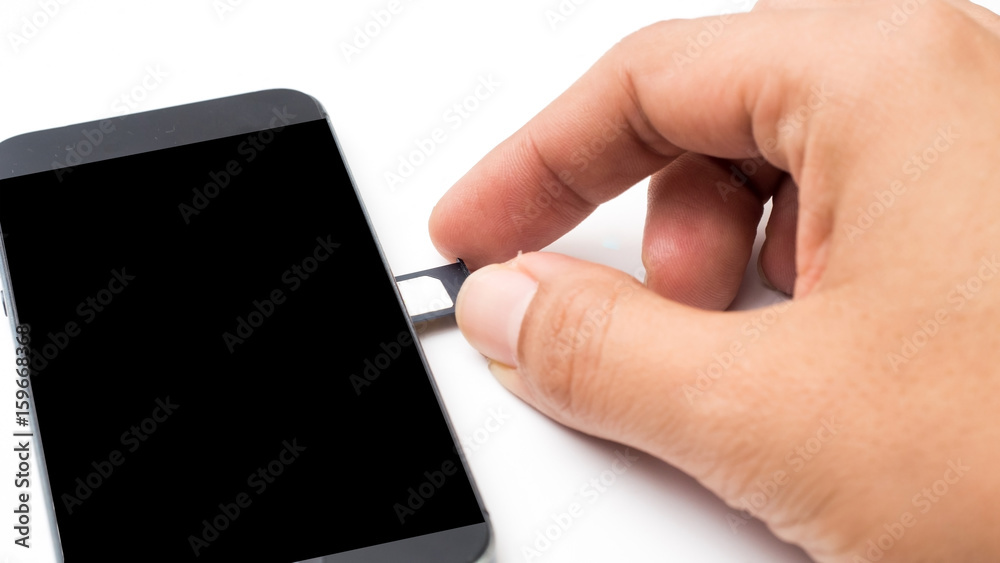close up hand ejecting sim card tray from smart phone / mobile phone close up hand ejecting sim card tray from smart phone / mobile phone