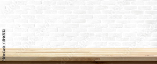 Wood table top on white brick wall background © Atstock Productions