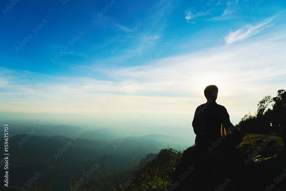 Yoga practicioner with blue sky meditation on high mountain Yoga practicioner with blue sky meditation on high mountain