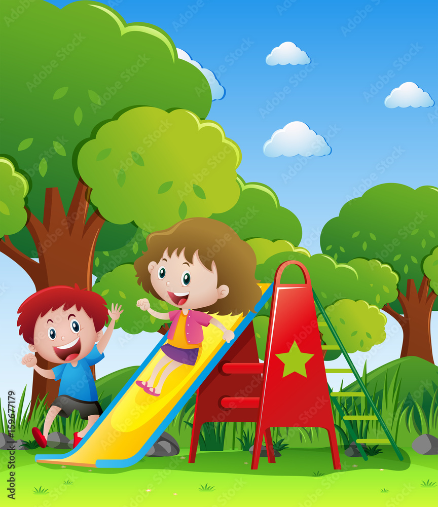 Two kids playing slide in park