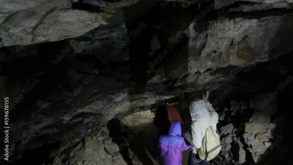 People walking through the cave People walking through the cave