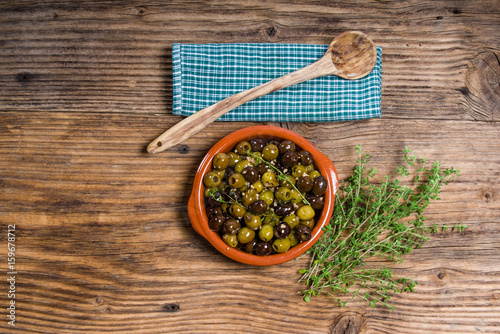 Fototapeta Naklejka Na Ścianę i Meble -  Green and black olives with wooden spoon
