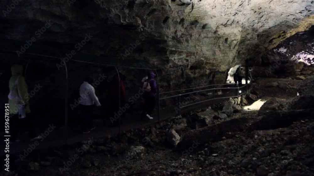 People walking through the cave People walking through the cave