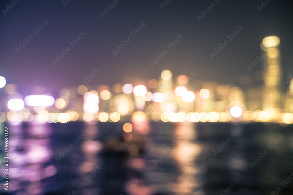 Blurred abstract background of cityscape at sea harbour hong kong at night time,urban life,vintage filter