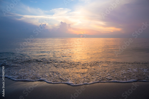 Beautiful sky at sunrise at the beach and waves