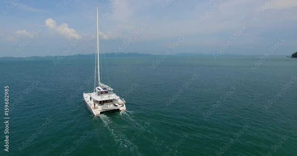 Aerial:Beautiful luxury yaht with pretty model sailing in Andaman sea. Thailand. Aerial:Beautiful luxury yaht with pretty model sailing in Andaman sea. Thailand.