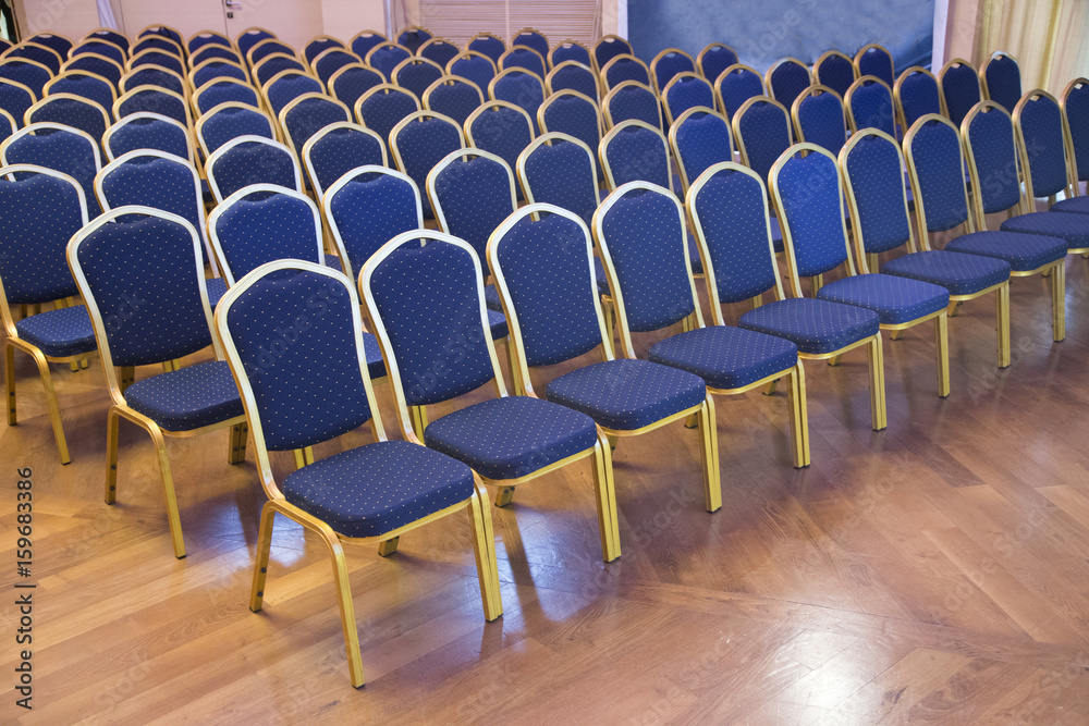 Naklejka premium Empty blue colored auditorium seats in unknown business hall