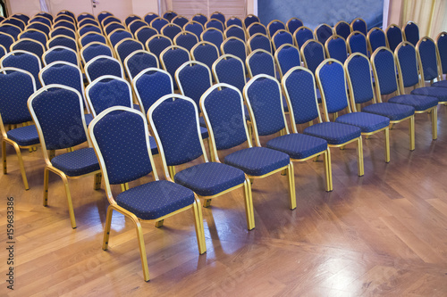 Empty blue colored auditorium seats in unknown business hall