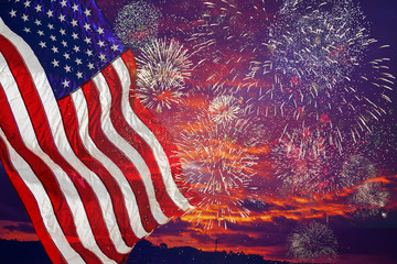 United States Flag, lots of fire works against the darkened sky.