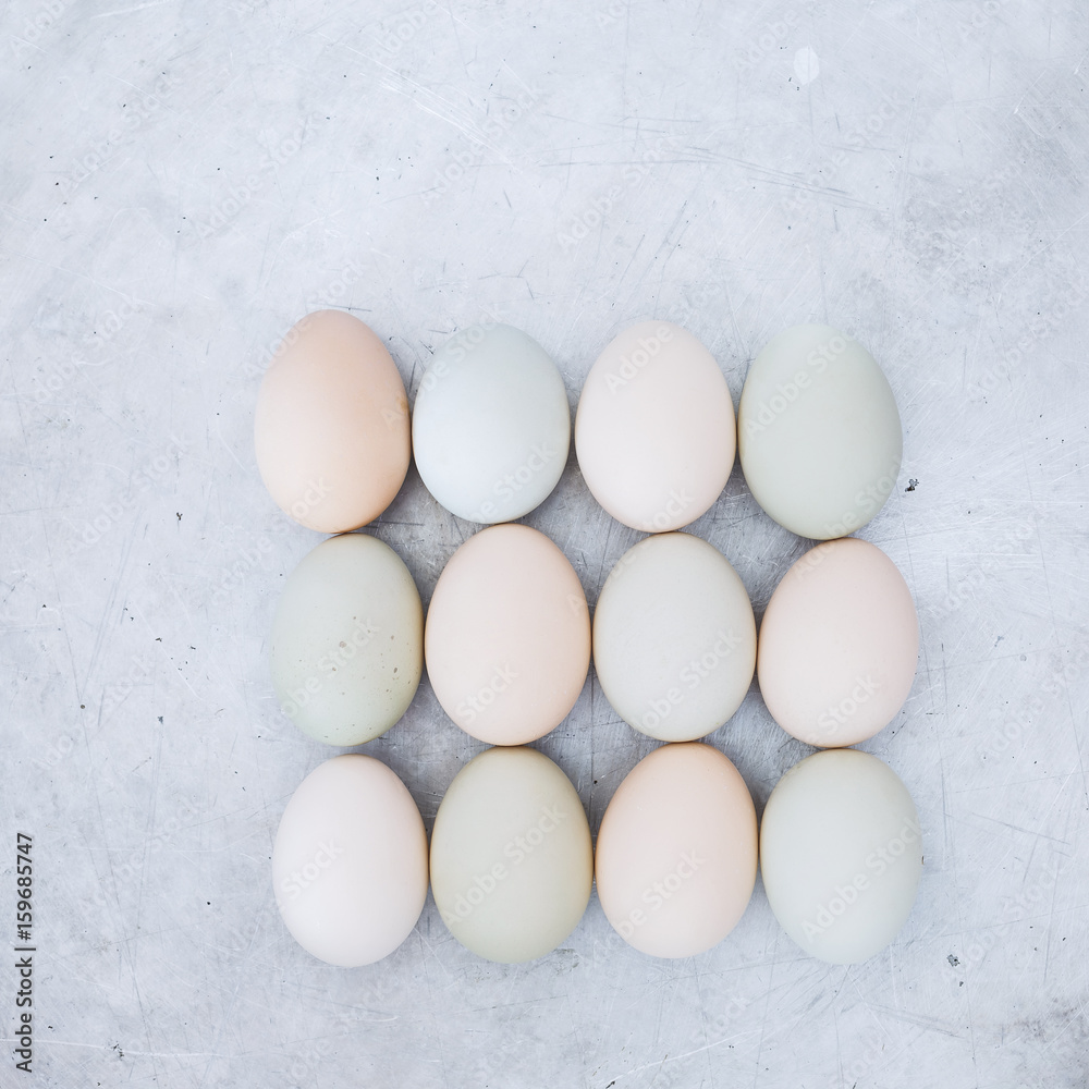 Fresh chicken eggs on rustic metal background, organic farming concept. Top view, blank space, vintage toned image Fresh chicken eggs on rustic metal background, organic farming concept. Top view, blank space, vintage toned image