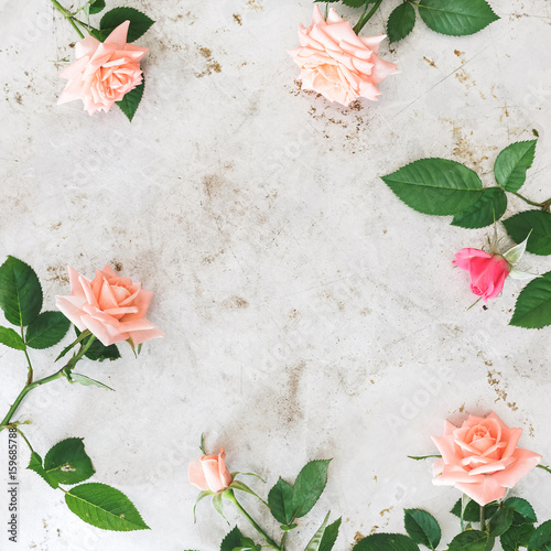 Pink roses arranged on rustic metal surface. Top view, blank space, vintage toned image