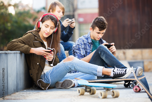 Teenagers with mobile phones
