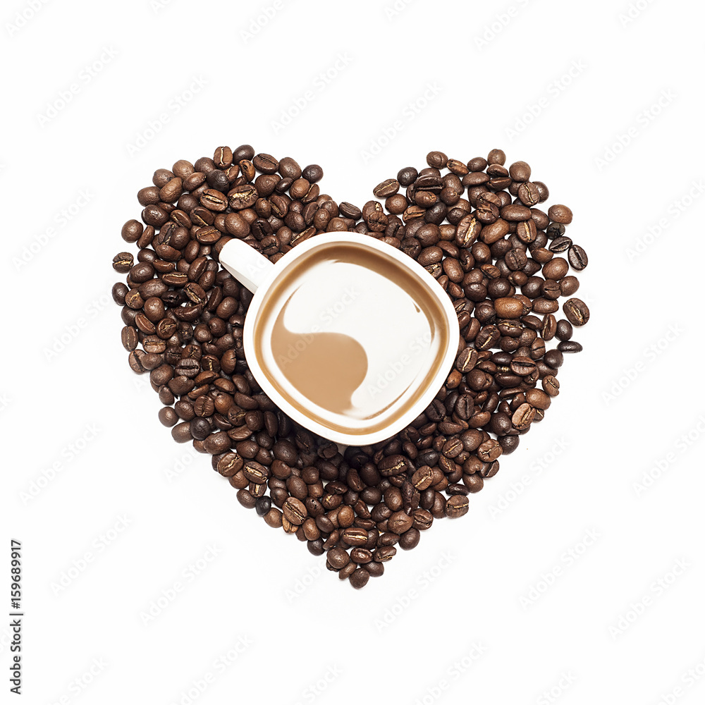 Cup of coffee surrounded by coffee beans in shape of heart on white background Cup of coffee surrounded by coffee beans in shape of heart on white background