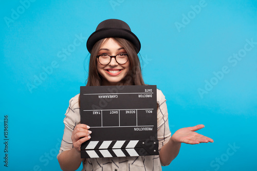 Woman posing with clapboard photo