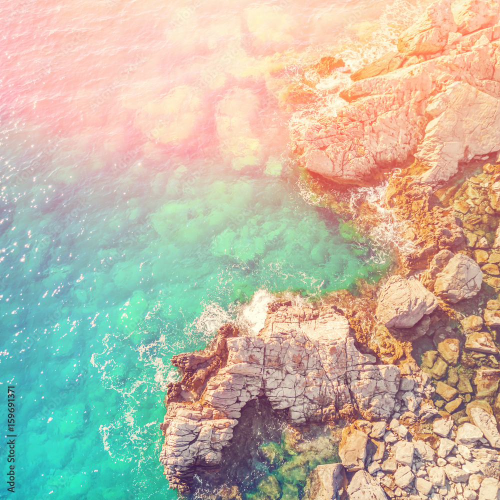 Fototapeta premium Rocky seashore, top view in the sunlight