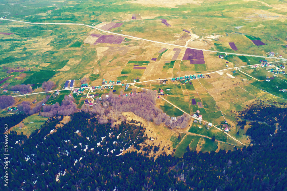 Fototapeta premium Top view of a village near the forest