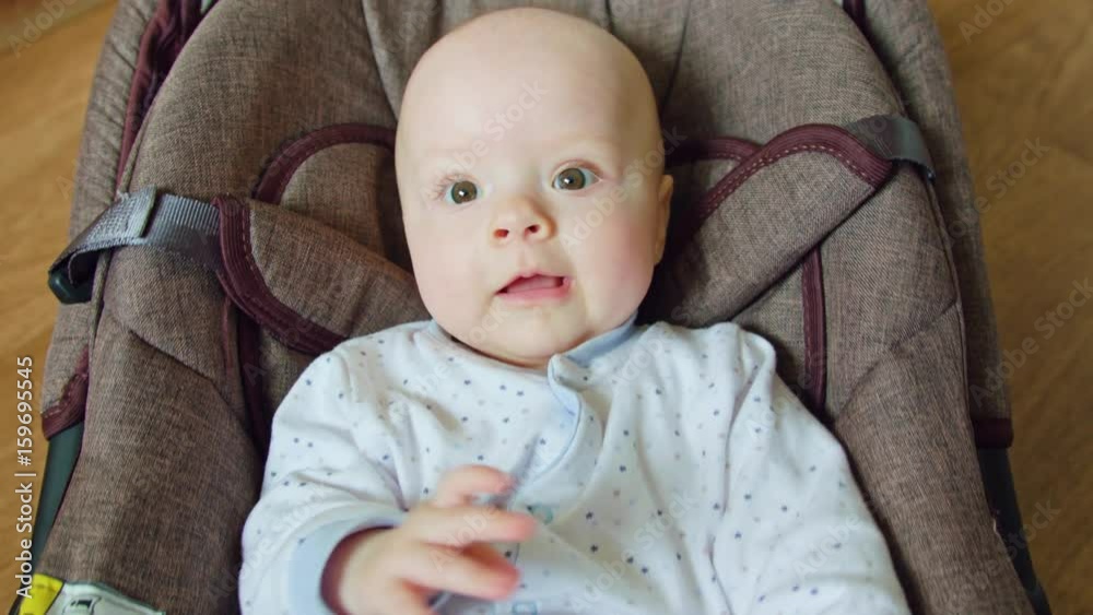 Adorable cute baby lying in pram. Medium shot Adorable cute baby lying in pram. Medium shot