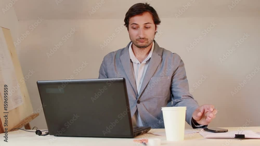 Man working on laptop and with documents Man working on laptop and with documents