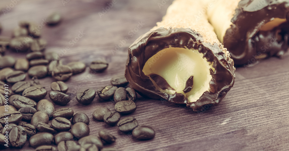 delicious sicilian cannolo cannellino sweet with pastry hazelnut near coffee beans delicious sicilian cannolo cannellino sweet with pastry hazelnut near coffee beans