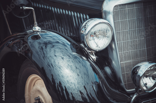 Headlights and body of an old classic car at an exhibition of vintage cars