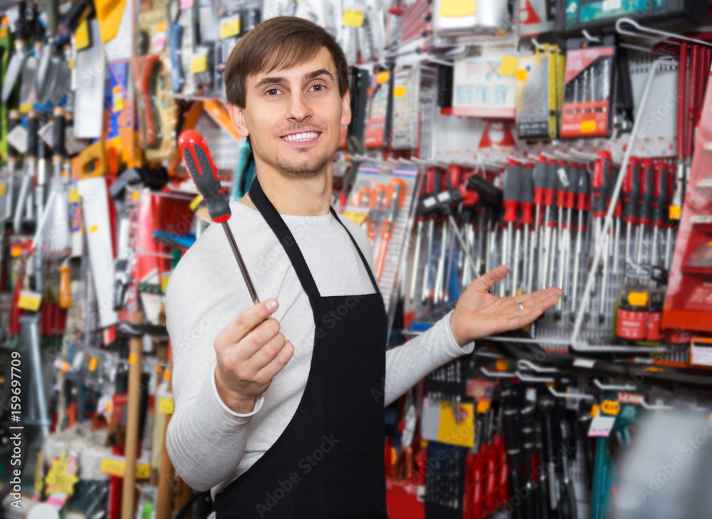 Male seller posing at tooling section