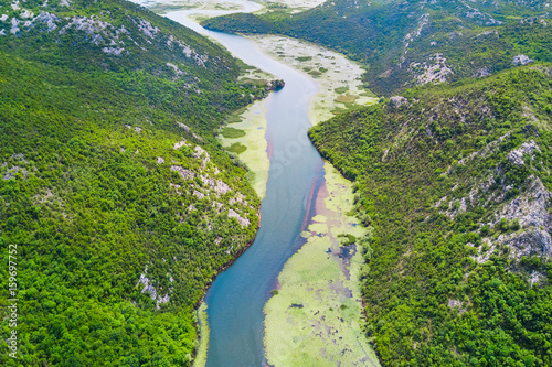 Top view of a river covered with green algae in the mountains