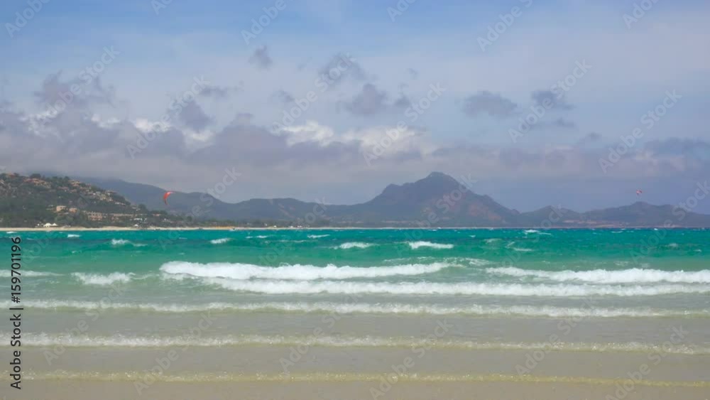 Kitesurfing in a Windy Bay in Sardinia Italy Kitesurfing in a Windy Bay in Sardinia Italy