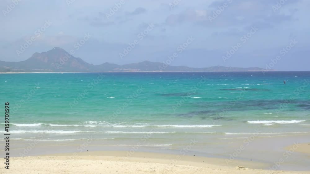 Kitesurfing in a Windy Bay in Sardinia Italy Kitesurfing in a Windy Bay in Sardinia Italy