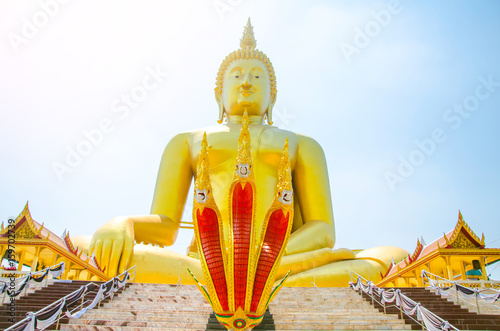 Golden Buddha statue of Big Buddha over blue sky